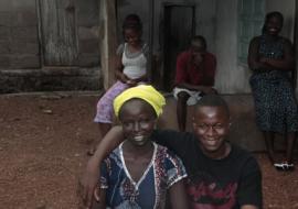 First patient discharge from the Ebola Treatment centre posing with husband