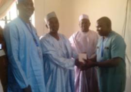 WHO State coordinator presenting oily chloramphenicol to the Kebbi State Commissioner of Health.