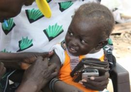 A child recieves measels vaccination at arrival at Juba Port