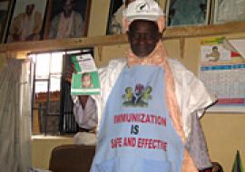 Kekun Nahuche displaying measles campaign materials
