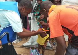 Health worker administering malaria drug to an eligible child during the 3rd  round SMC campaign at El-Miskin camp in Jere LGA.