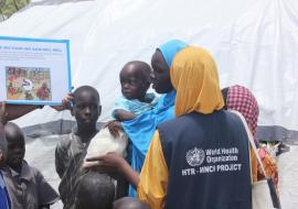 WHO personnel raising awareness on proper hygiene and prevention against cholera