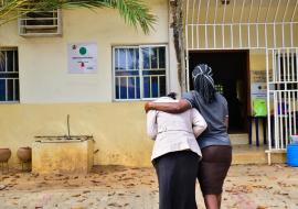 A patient supported by a relative into a health facility in Abuja