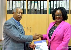 WHO Representative Dr Yonas Tegegn Woldemariam hands the MOU to the Dean of MUSPH Dr Rhoda Wanyenze