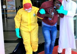 Health workers evacuate a suspected Ebola patient at Entebbe International Airport during the SIMEX 