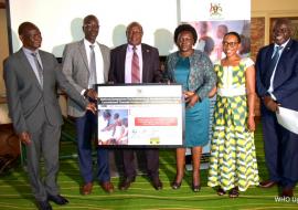 Left-Right: Dr Jackson Oryem, Mr. Ejoru Alphonse, Hon Charles Bakabulindi, Hon Sarah Opendi, Dr Annet Kisakye and Dr Jackson Driwale display the commitment board signed to improve HPV coverage in Uganda