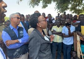 Minister of Health Dr Jane Ruth Aceng (black suit) addresses a gathering in Arua district about Ebola Virus Disease. Looking on is the WHO Representative in Uganda, Dr Yonas Tegegn Woldemariam (WHO branded jacket) 