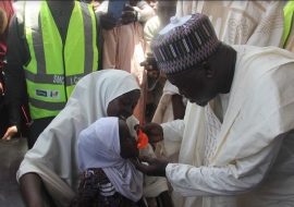 Emir of Bade, Alhaji Abubakar Umar Suleiman administers Malaria drug to an eligible child at a flag-off ceremony.