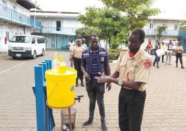 Security guards deployed at WHO office in Juba,  practices hand washing as a recommended measure to prevent the spread of #COVID-19