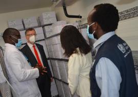 Dr Collins Tabu of national Vaccines programme, shows the storage of the  Covax vaccines to Dr Rudi Eggers, WHO Rep, Ms Maxx  UNICEF Rep and Dr Kibet Sergon during the visit  to the Central  vaccine stores in Kitengela