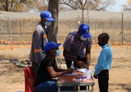 Technical staff assessing a learner at Parakarungu Primary School in the Chobe district on MDA impact