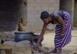 Fatimah Saliu, uses firewood to prepare meals for her family.