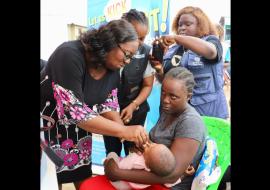 Dr. Catherine Cooper, Liberia's Chief Medical Officer administers first vaccine during the nationwide polio vaccination campaign launch in Liberia