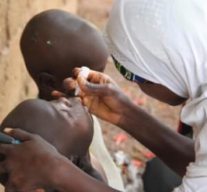 Vaccinator drops oral polio vaccine into the mouth of eligible child - Igabi LGA