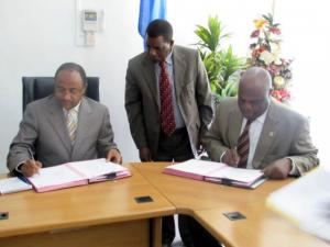 The WHO Representative, Dr. Rufaro Chatora and the Minister for Health and Social Welfare, Hon.Dr Hussein Ali Mwinyi signing certificates of transfer