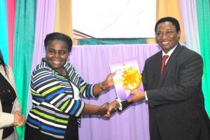 WHO Officer, Dr Joyce Nato receives the launched strategy document from DMS Dr Jackson Kioko