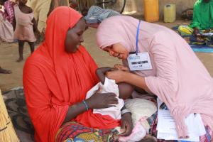 Community Health Champion bonding with caregiver for delivery of lifesaving messages at Cuton House IDPs camp in Borno_Photocredit_WHO-CE.Onuekwe