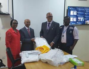 WHO country Representative Dr Wondimagegnehu Alemu hands over personal protective equipment to Chief Executive Officer of the Nigeria Centre for Disease Control Dr Chikwe Ihekweazu