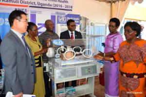 Dr Olive Sentumbwe (right) showing Dr Diana Atwine one of the incubators that were donated. Looking on is Dr Bayo Fatunmbi (red tie), DHOs from Iganga and Kamuli and Mr Kim Sangchul from KOICA