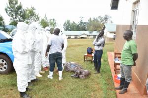 Ministry of Health and WHO staff teaching health workers proper donning and doffing of a Personal Protective Equipment