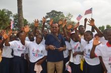   Dr. Betru UNAIDS Country Director (center) with high school students in Ganta