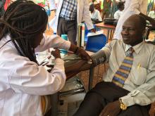 Dr Bakhit Mawien, Director General Wau Teaching Hospital donating blood. He said,  We can live without one arm or one eye but cannot live without blood 