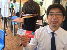 H.E. Kiya Masahiko, Japanese Ambassodar displaying his card after donating blood