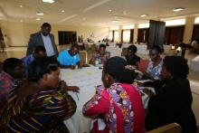 Participants engaged in group discussion led by a facilitator