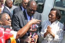 The WHO Representative a.i. Dr. Custodia Mandlhate handing over the keys of one of the land cruisers to the Minister of Health, Dr. Chitalu Chilufya in the presence of Ms Uzoamaka Gilpin, Health Advisor from DFID