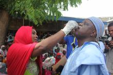  Borno state Commissioner for Health receiving the cholera vaccine during the flag-off ceremony at Muna IDPs camp.