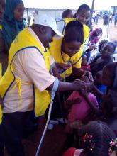   Mr Harold Kipchumba the Kenya Goodwill Immunization ambassador vaccinating a child during a polio campaignin Nairobi