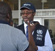 WHO Representative Dr Charles Sagoe-Moses speaking to the media during the Head of State visit to the affected communities