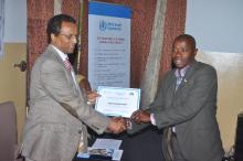 Dr. Desta A. Tiruneh presenting certificate to a representative of one of the Media institutions