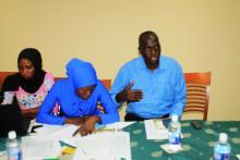Representative of the Tobacco Control Committee from the Ministry of Trade (right) expressing his individual commitment  and that of his institution to controlling the Tobacco epidemic in The Gambia 