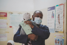 Mr Aliyu Bello and his daughter with Immunization Card