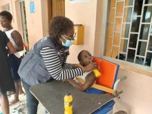 A WHO staff member with one of the beneficiaries
