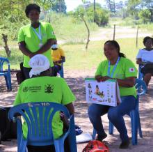Community Health Workers demonstrating their work in the community on nutrition.