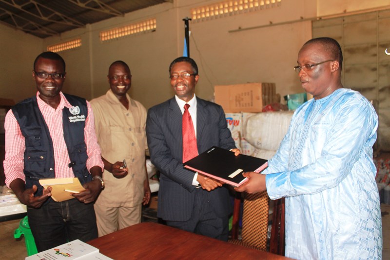 Hon. Omar Sey receiving the signed document of the handed-over items from WR
