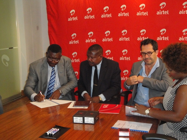 Dr Eugene Nyako, left signing the MOU for the Ebola Virus Disease hotlines