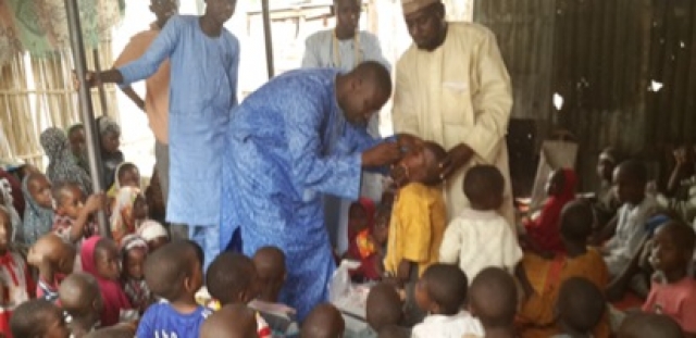 Islamic scholar assisting with Vaccination