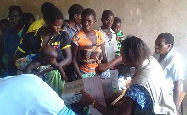 WHO Emergency Response Team member dispensing drugs at a mobile clinic WHO/H. Kubwalo