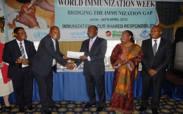 Cabinet Secretary Mr James Macharia awards a certificate to Dr Ephantus Maree, Head of Unit of Vaccine and Immunization Services (UVIS) at the launch of World Immunization week in Kenya, Nairobi. Looking on: Dr Jackson Kioko, Head, DPPHS, Dr Custodia Mandlhate, WHO Country Representative and Dr Nicholas Muraguri, Director of Medical Services