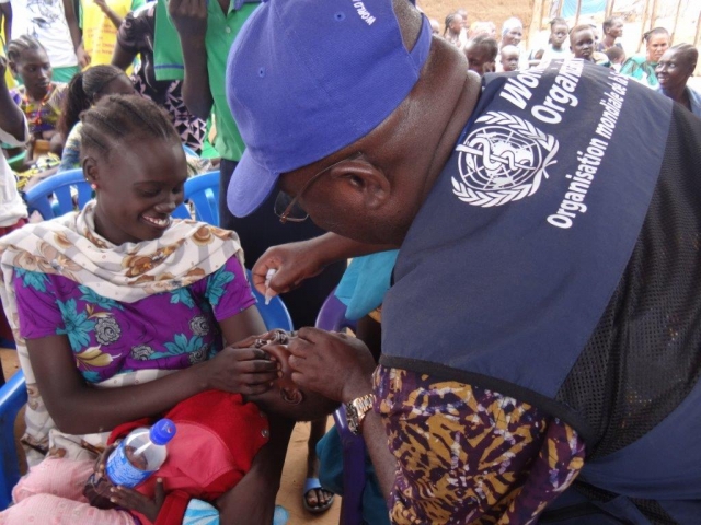 Dr Bimpa Lupanzula, gives an anti-polio drop to a child during the campaign launch at Jebel Dinka