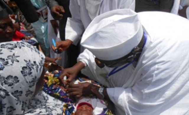 Governor vaccinating a baby with OPV