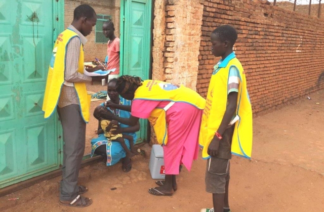 Children receive polio vaccination drops during a house-to-house vaccination campaign in Awiel, South Sudan