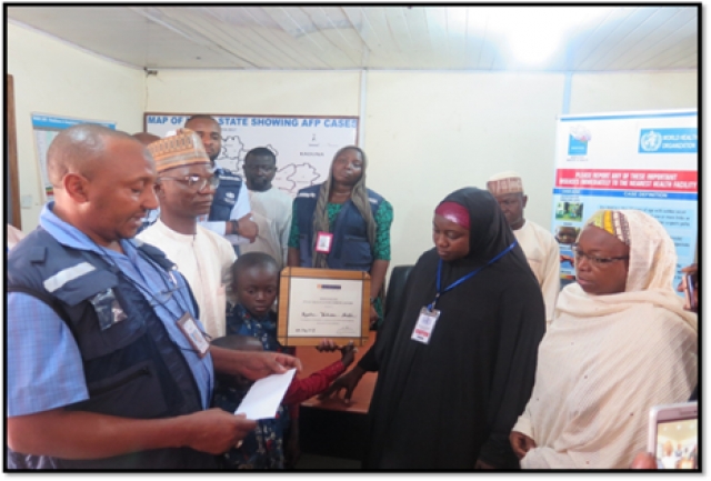 Presentation of plaque-certificate to widow of Late Isyaku Yakubu, by WHO State Coordinator in Niger State