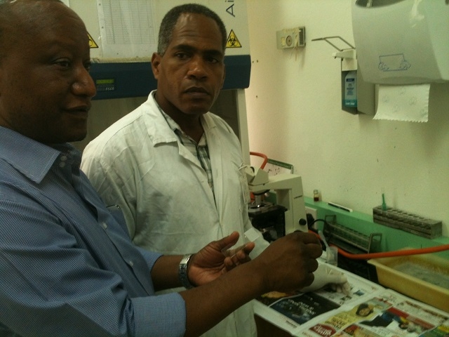 WHO Consultant Dr Mwandawiro discusses specimen processing procedure to one of the Laboratory Technician