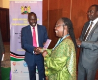 Health PS, Prof Segor hands a copy of the guidelines to the WR, Dr Custodia during the launch
