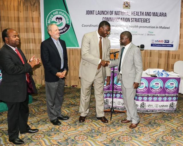 Dr Eugene Nyarko, WR Malawi shaking hands with the Minister of Health, Honorable Dr Peter Kumpalume, MP