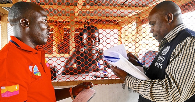 Liberia: Mr Tamba Alpha, surveillance officer, is inspecting isolation rooms at a Voinjama checkpoint with Mr Charles Ntege, WHO county coordinator. WHO/M. Winkler